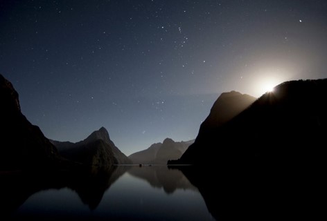 The sun sets and the stars are out in the Milford Sound. Stay at Milford Lodge to see the view.