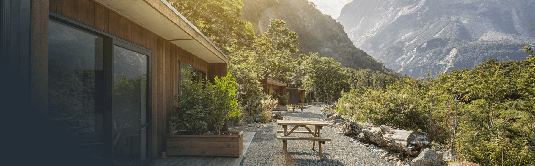 Picnic tables outside Milford Sound Lodge Mountain View Chalet accommodation.