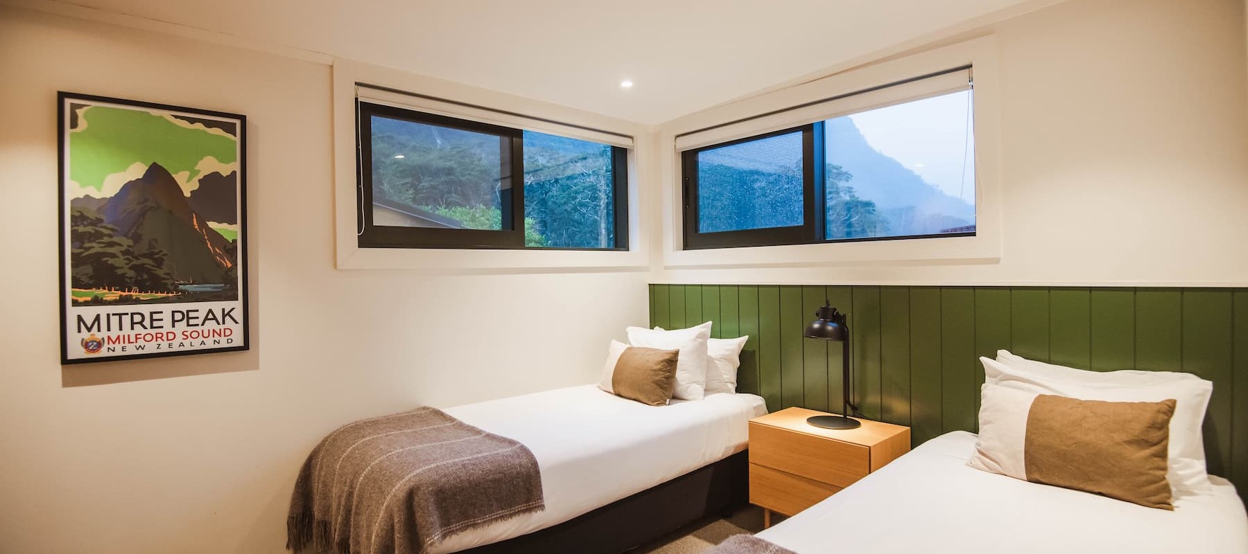 Two single beds on the 2-bedroom garden chalet at Milford Sound Lodge.