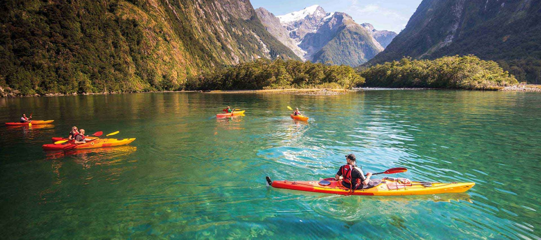 A group Kayaking on Milford Sound's clear blue waters. One of the Milford Sound Lodge's activities.