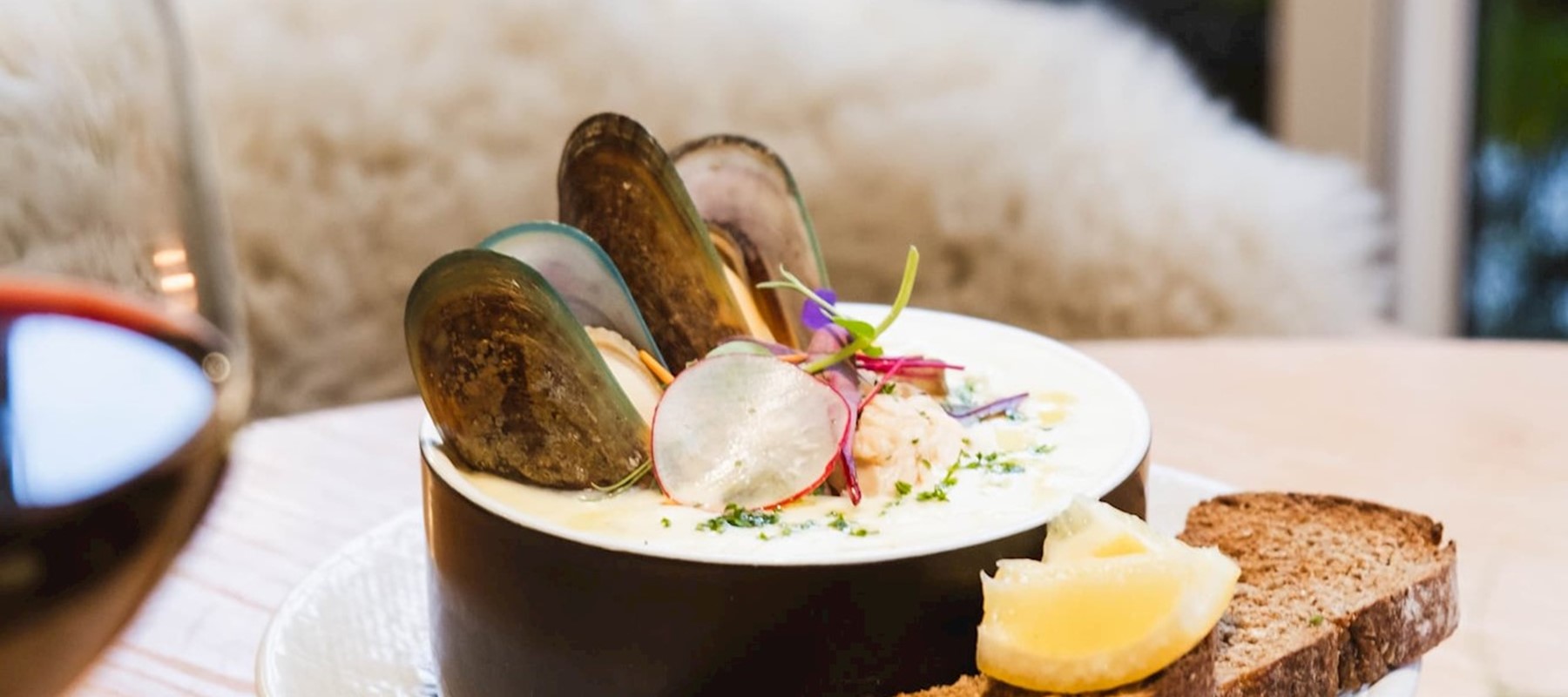 Seafood Chowder, served with a glass of red wine at Pio Pio Restaurant Milford Sound