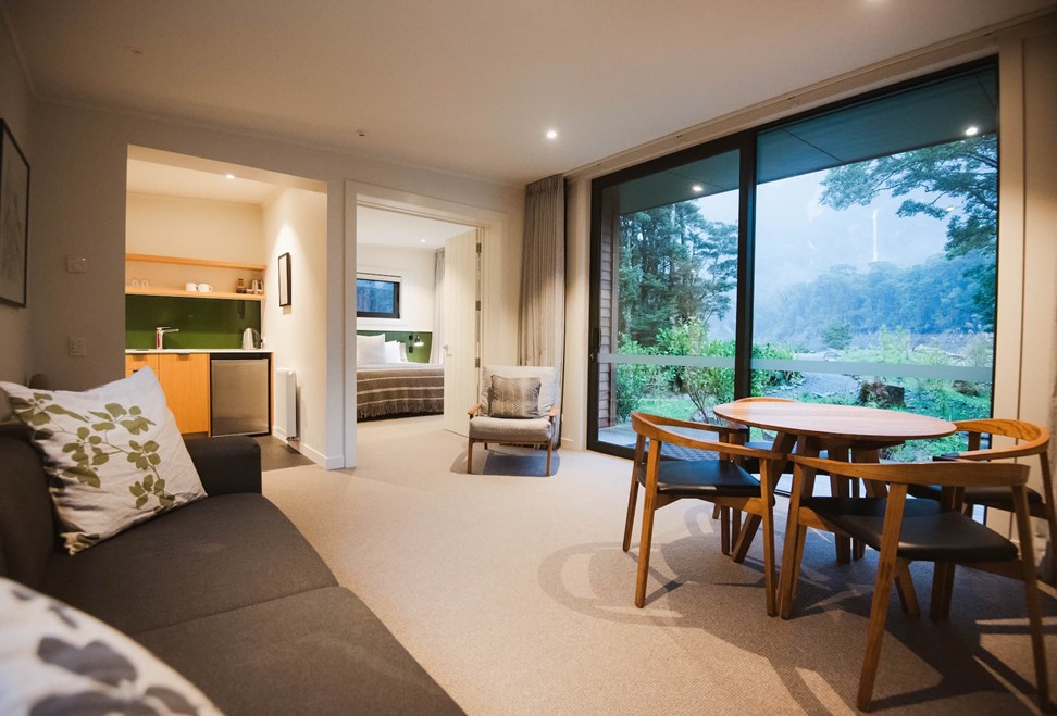 Views of the kitchen, bedroom and sitting room at Milford Sound Lodge's 2-Bedroom River Chalet.