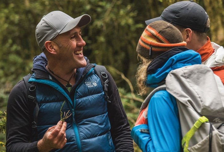A tour guide shows guests the through the bush on a private Milford Sound Lodge tour.